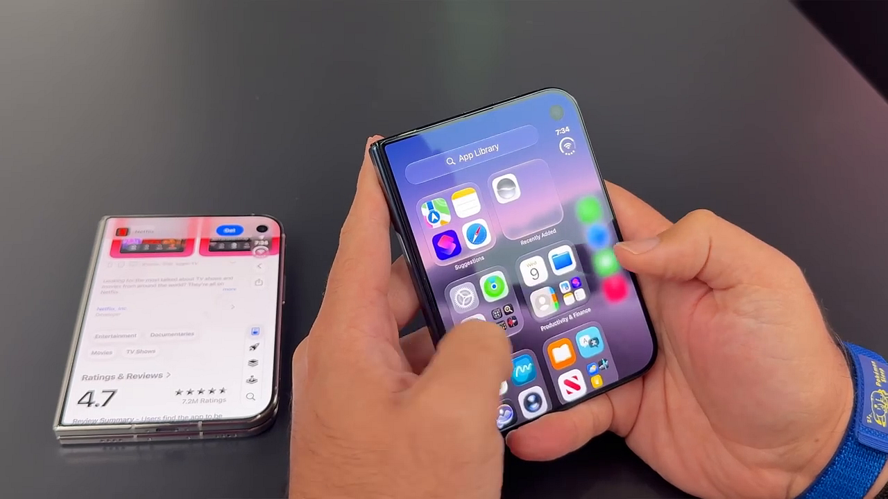 Two hands holding the iPhone Duo fully open to show the home screen with a widget and app icons
