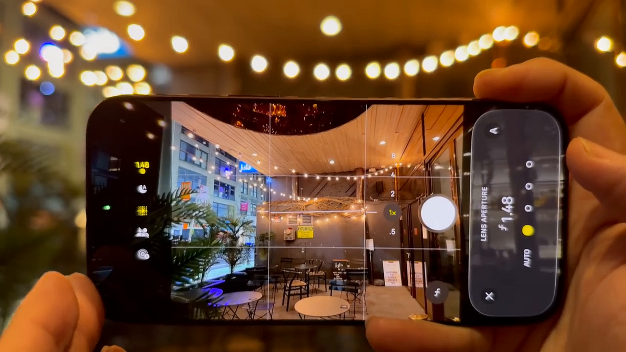 Native camera interface displaying the manual lens aperture dial set to f/1.48 against a blurred outdoor background